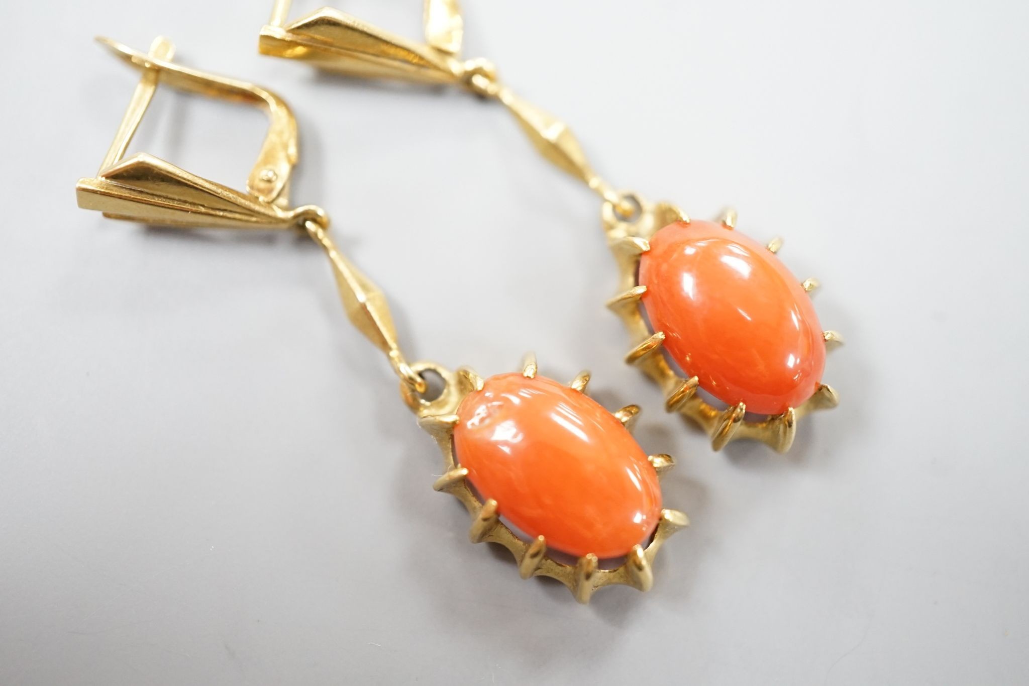 A pair of 18k and oval coral bead set drop earrings, 39mm, gross weight 6.8 grams.